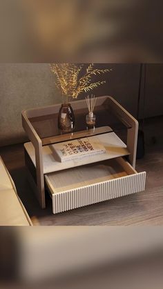 a coffee table with two trays on it and a vase filled with flowers next to it