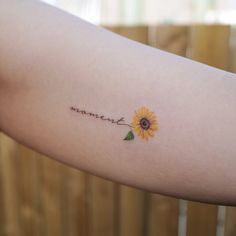 a woman's arm with a sunflower and the word love written on it