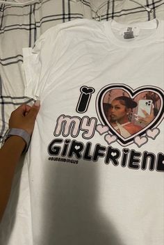 someone is holding up a t - shirt that says i love my girlfriend