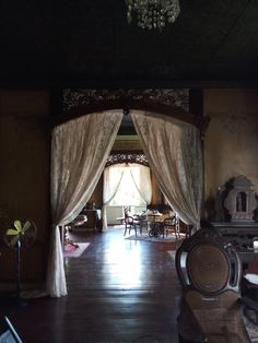 a living room filled with furniture and curtains