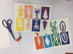 four different colored paper cut outs with scissors