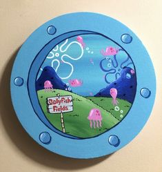 a blue clock with an image of animals on it's face and the words baby fish fields