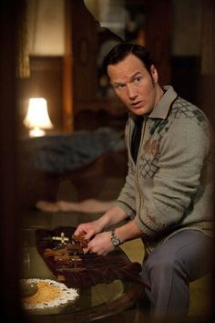 a man sitting at a table with food in front of him