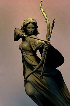 a statue of a woman with a bow and arrow in her hand, holding a staff