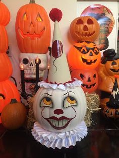 a table topped with lots of halloween pumpkins