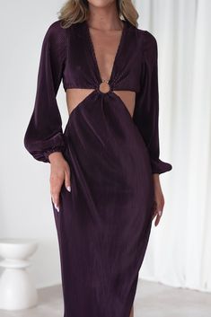 a woman wearing a purple dress with cut outs