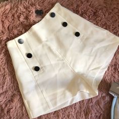 New! White High Waist Shorts With Black Buttons. Side Zipper. Extra Buttons Attached. Never Worn. Needs To Be Steamed But Otherwise Perfect Condition. Chic Buttoned Shorts For Day Out, Fitted White Shorts With Buttons, Chic High Waist White Shorts, White Fitted Buttoned Shorts, High Waist Cream Shorts For Work, High-waisted Cream Shorts For Work, Trendy White Shorts For Workwear, Trendy White Bottoms With Buttons, Chic High Waist Cream Shorts