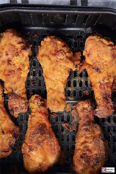 chicken is cooking on an outdoor grill