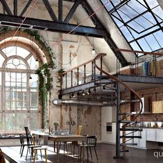 an industrial loft with exposed brick walls and metal staircase leading up to the second floor