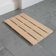 a wooden pallet sitting on top of a tiled floor