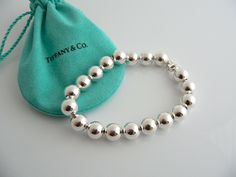 Overview:Offered for sale is a wonderful Tiffany classic. Whether you are just starting your Tiffany collection or are thinking of adding another piece, this one is perfect for you. Tiffany & Co.'s Sterling 19 Ball / Bead bracelet is a Tiffany classic that will never go out of style. The piece makes a statement in its own subtle/simple way. It will most certainly be a piece that you will turn to over and over again, making it great value for your money. It is a wonderful bracelet that fits a Gift Pouch, Bracelet Bangle, Tiffany Heart, Heart Charm Bracelet, Bead Bracelet, Tiffany & Co., Out Of Style, Go Out, Solid 925 Sterling Silver