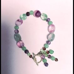 This Is A Gorgeous New Artisan Crafted 6” Pastel Green And Purple Glass Beaded Bracelet With Toggle Clasp! You Can Make A Fashion Statement In Perfect Style! You’re Going To Get Lots Of Compliments! Comes Already Gift Wrapped And In A Fancy Gold Gift Box! Makes An Excellent Gift For Yourself Or Your Loved Ones! Comes From A Smoke And Pet Free Environment. Please Ask Any Questions You Have. Offers Welcome! Thank You For Shopping With Us At Nancy’s Creative Treasures! Handmade Multicolor Amethyst Bracelets, Adjustable Green Amethyst Jewelry, Adjustable Multicolor Amethyst Bracelet, Adjustable Multicolor Amethyst Bracelets, Adjustable Purple Beaded Bracelets With Lobster Clasp, Handmade Adjustable Lavender Crystal Bracelet, Adjustable Handmade Lavender Crystal Bracelet, Pastel Green And Purple, Glass Beaded Bracelet