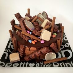 there is a cake made to look like it has chocolate and candies on top