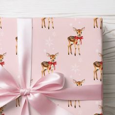 a pink wrapping paper with deers on it