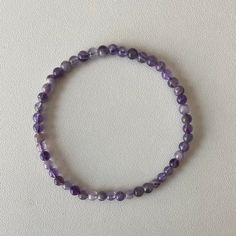 Enhance your accessory collection with this Amethyst 4mm Bead Bracelet, showcasing the elegance of genuine amethyst beads. Each bead features the distinctive purple hues and natural sparkle of amethyst, known for its calming and spiritual properties. This delicate bracelet is perfect for everyday wear or special occasions, offering a subtle yet refined touch. Amethyst is traditionally believed to promote peace, balance, and spiritual growth, making this bracelet both a stylish and meaningful add Purple Round Beads Crystal Bracelet For Healing, Purple Amethyst Beaded Bracelets, Purple Amethyst Bracelets With 8mm Beads, Spiritual Amethyst Bracelets With Polished Beads, Purple Crystal Bracelet With Gemstone Beads, Purple Amethyst Crystal Bracelet With Gemstone Beads, Amethyst Gemstone Beaded Bracelets, Adjustable Amethyst Round Bead Crystals, Purple Gemstone Beaded Bracelets