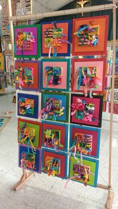 many colorful paintings are on display in a store