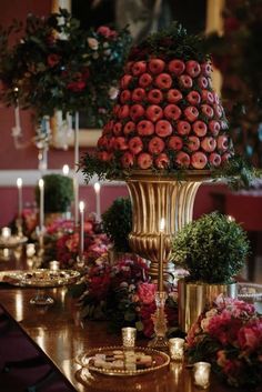 a table topped with lots of flowers and candles