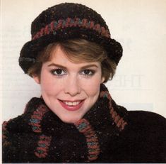 a woman wearing a knitted hat and scarf with a smile on her face in front of a white background