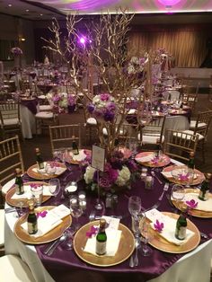 the table is set with wine bottles and place settings