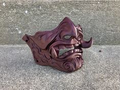 "Perfect for cosplay or display. Paintable, or ready to wear/display as-is. Available in two sizes: Large (6\" across) and Small (5.5\" across). Measurement is taken from the width of the face from cheekbone to cheekbone. Weighs approximately 12 oz. Shown here in the listing photos in the Mystic Brown option. Free shipping on domestic orders only! Original design by flioink. The Bear and Wolf Studio is an authorized manufacturer and seller of flioink designs." Oni Half Mask, Bear And Wolf, Samurai Mask, Handpainted Bags, Hobbit Hole, Half Mask, Painted Bags, Mini Succulents, The Mystic