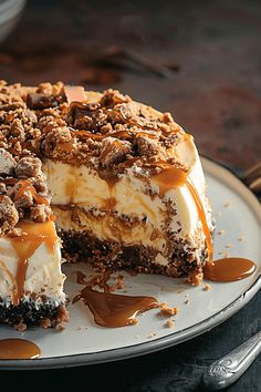 a cheesecake covered in caramel and pecans on a plate