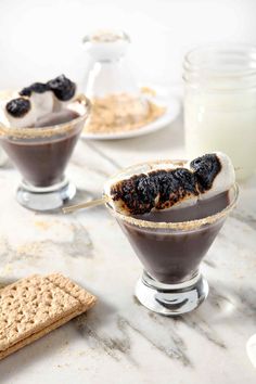 two desserts are sitting on a marble table