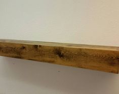 a piece of wood sitting on top of a white wall