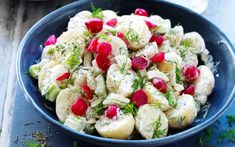 a blue bowl filled with cucumber and radishes