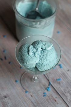 two glasses filled with ice cream on top of a wooden table