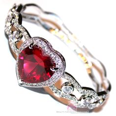 "Prophet's Heart Ruby Red HEART CZ BRACELET - Special! ~ Matches our Prophet's Heart Ring ~ A Prophet's Heart bracelet features the highest quality ruby red cz available. Gorgeous mini cz's in clear and and a beautiful deep ruby red heart CZ. The center ruby red cubic zirconia measures 3/4\" x 3/4\". The entire heart design measures about 1\" across and 1\" from top to bottom. The side design measures about 1/2\" wide (side) and about 1/4\" (back)on the back of the bracelet and going thicker tow Beauty For Ashes, Valentines Bracelets, Cz Bracelet, Ashes Jewelry, Side Design, Wedding Jewelry Bracelets, Heart Gifts, Charm Bangle, Valentine Day Love