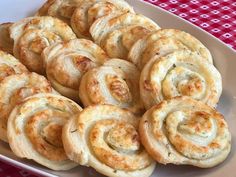 a white plate topped with lots of cinnamon rolls