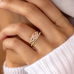 a woman's hand with a ring on it and a diamond in the middle