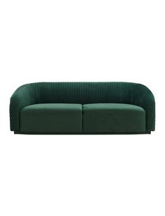 a green couch sitting on top of a white floor