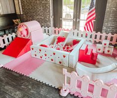 there is a pink and white play set in the middle of a room with american flags