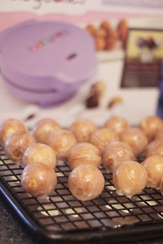 doughnuts are cooling on a wire rack in front of a package of donuts