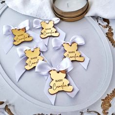 baby shower favors on a plate next to a candle