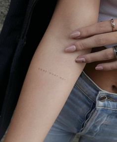 a woman's arm with the word love written on it, and her ring