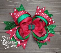 "This Glitter bow comes in two options that mirror each other. Choose from either the bow featuring glitter green ribbon and a green glitter present center or the red glitter ribbon with the red glitter present! It the perfect bow to add a little sparkle to your Christmas! Measures approximately 4 1/2\" x 5\". This bow is stiffened to help maintain its shape. This bow is secured to a 1.75\" covered alligator clip and comes with the standard slip grip to help keep it in place. **This bow may cont Hair Bows Diy Ribbon, Holiday Hair Bows, Bows Christmas, Christmas Hair Accessories, Perfect Bow, Bows Diy Ribbon, Holiday Hair, Christmas Hair Bows, Glitter Ribbon