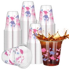 plastic cups with pink and blue designs are shown in front of the cup, which is full