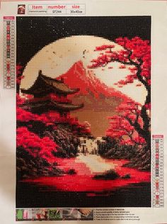 a cross stitch picture with a full moon in the background and red trees around it