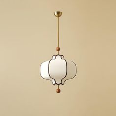 a white and gold light hanging from a ceiling