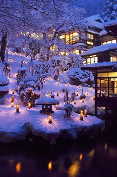 a snowy landscape with lit candles and trees