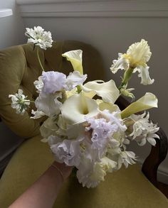 a bouquet of flowers sitting on top of a green chair