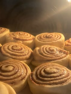 cinnamon rolls are being cooked in an oven