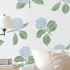 a living room scene with focus on the sofa and wallpaper featuring hydrangeas