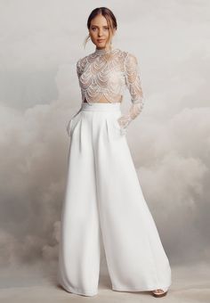 Cut from luxurious stretch crêpe, the Alexis trousers feature gorgeously flattering seam lines and fashion-forward flared legs. These trousers are perfect for those wanting an alternative to a traditional wedding dress look. These beautifully structured, high-waisted trousers feature front box pleats and back darts, wh Bridal Crop Top And Pants, Wedding Trousers Brides, Alternative Bridal Outfit, Practice Tattoos, Bridal Pants, Wedding Pantsuit, Wedding Pants, Catherine Deane, Woman In White