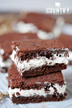 three brownies with white frosting stacked on top of each other