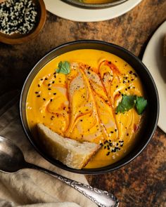 a bowl filled with soup and bread on top of a table