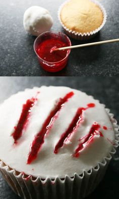 cupcakes with white frosting and red icing on them, next to an empty cupcake liner