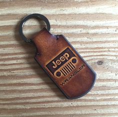 a jeep leather keychain on a wooden surface